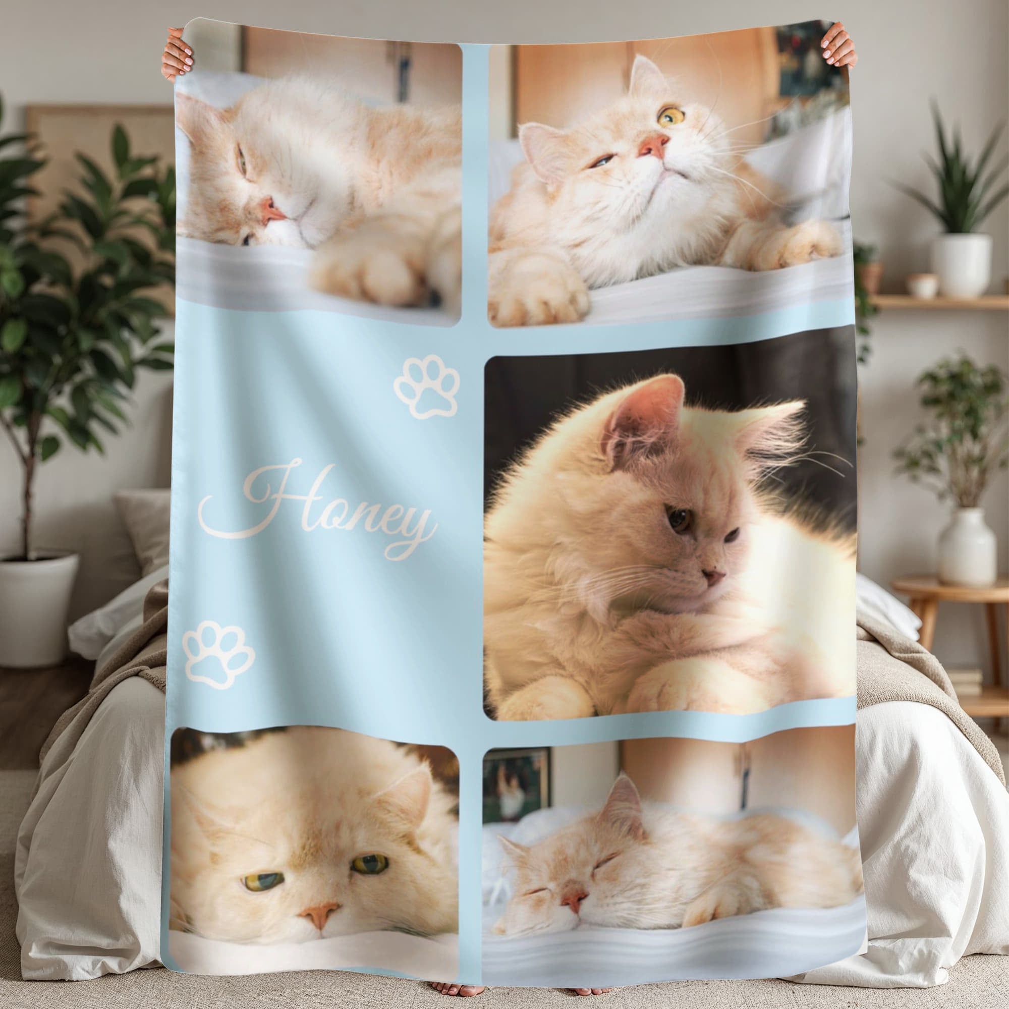 Blanket with images of a cat and the word 'Honey' on a light blue background.