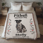 Pitbull-themed blanket with text and a dog illustration on a bed in a bedroom setting.