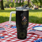 Black travel mug with green handle featuring a dog design, placed on a table with donuts and condiments.