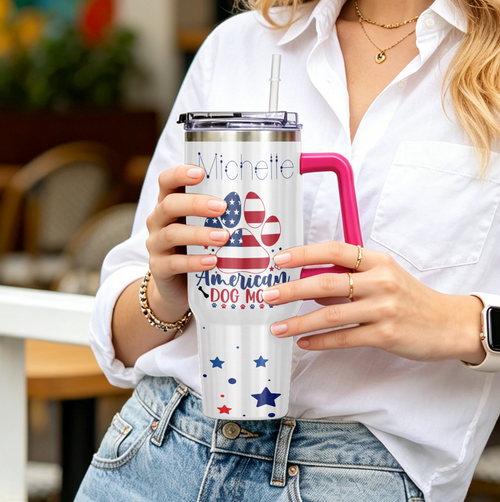 Person holding a personalized tumbler with patriotic design and text.