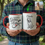 Two mugs held by a person with one showing 'Loved by a Golden Retriever' and the other with a dog illustration and name.