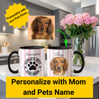 Two mugs with a dog design and text in a kitchen setting, with flowers in the background.
