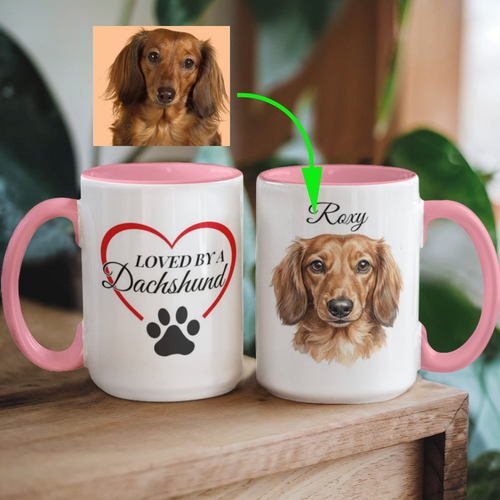 Two mugs with pink interior and handle, featuring a dachshund and text 'Loved by a Dachshund'.