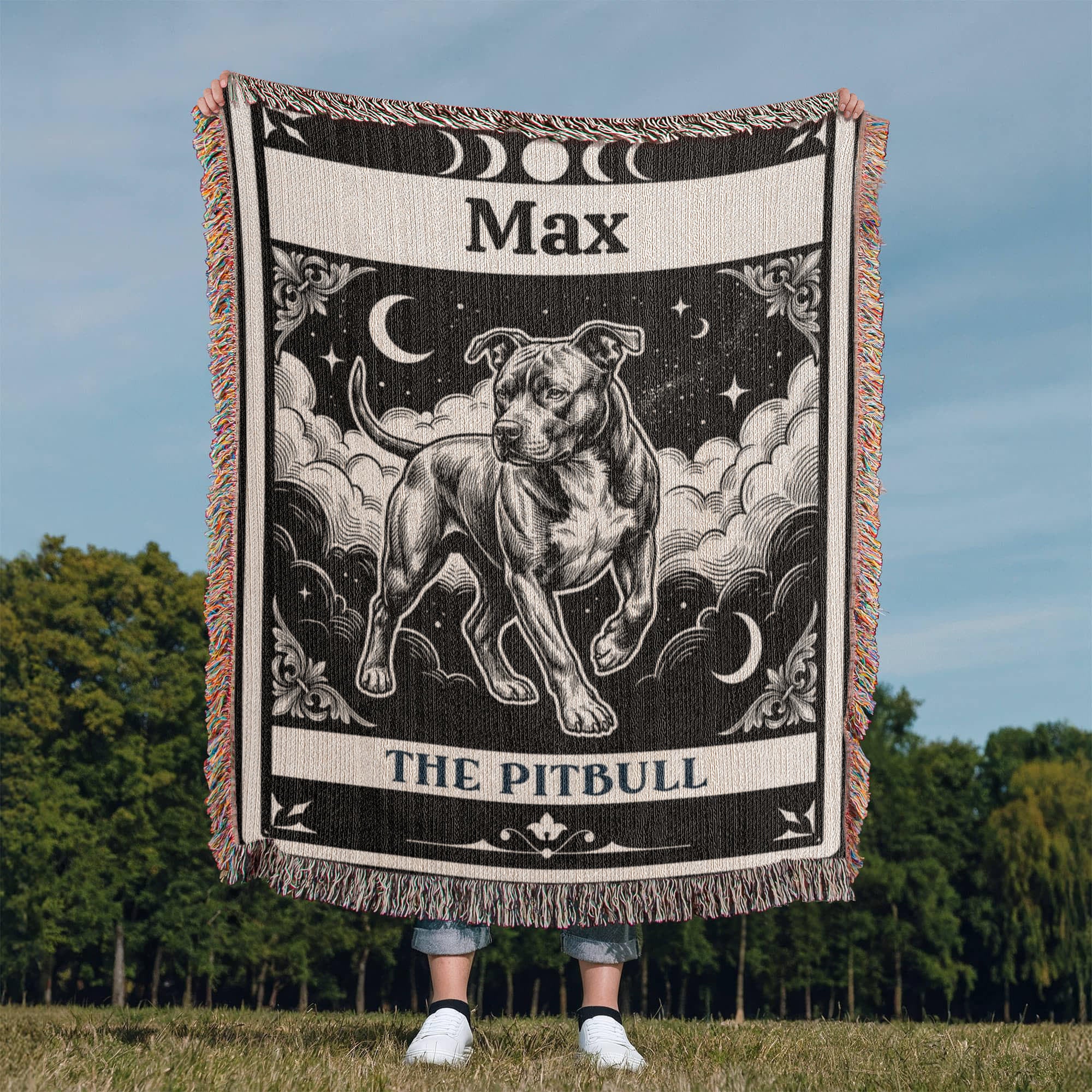 woven Blanket with a tarot card design of a pitbull personalized with the name 'Max' against a starry night sky, held by a person outdoors.
