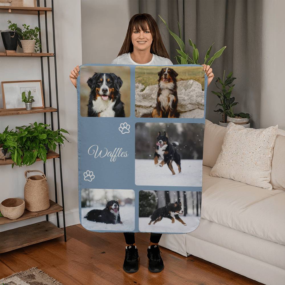 Person holding a blanket with multiple images of a dog named Waffles.