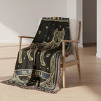 Decorative blanket with wolf design draped over a chair in a minimalistic room.