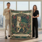 Two people holding a decorative blanket with a pitbull design in a modern building setting.