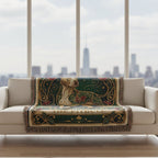 Decorative blanket on a white sofa with a cityscape view through large windows.