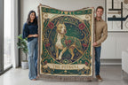 Two people holding a decorative blanket with a pitbull design in a modern living room.