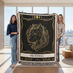 Two people holding a decorative blanket with a lion design in a modern living room.