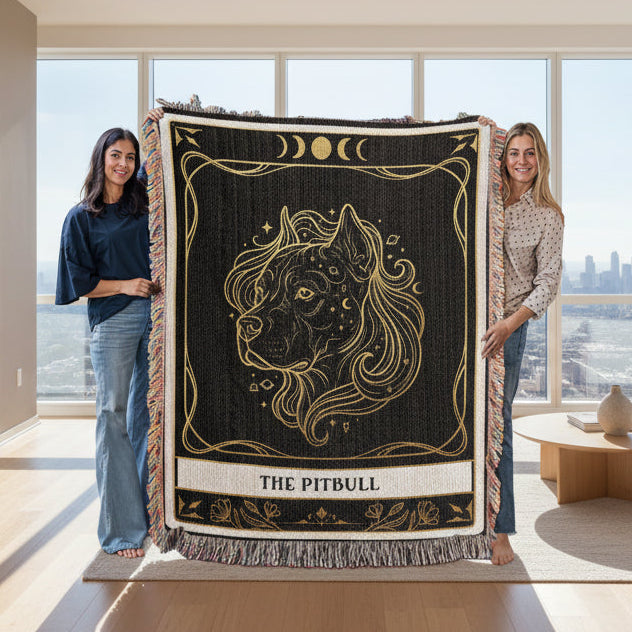 Two people holding a decorative blanket with a lion design in a modern living room.