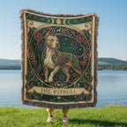 Decorative blanket with a dog design held by a person by a lake