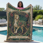 Person holding a decorative blanket with a pitbull design by a poolside.