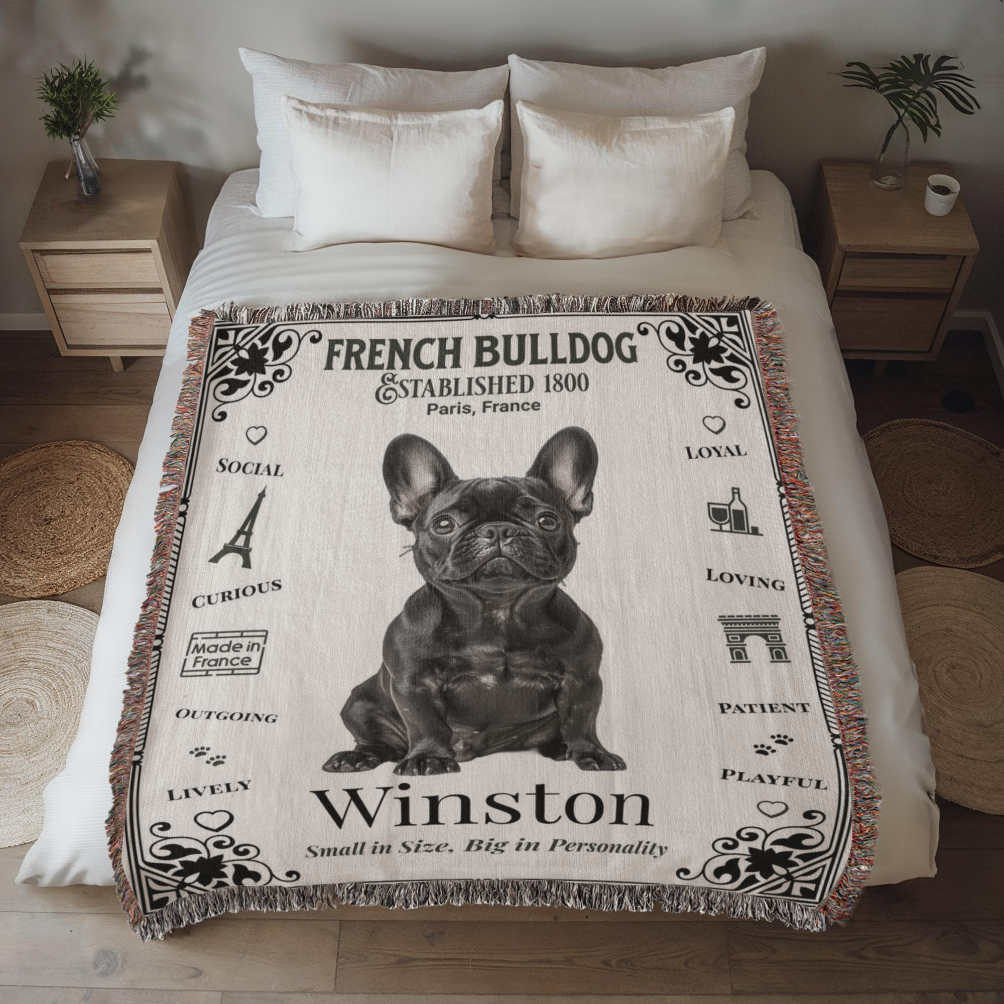 Bed with a French Bulldog-themed woven blanket featuring the name 'Winston' in a bedroom setting.Personalized with the name and photo of your Frenchie.