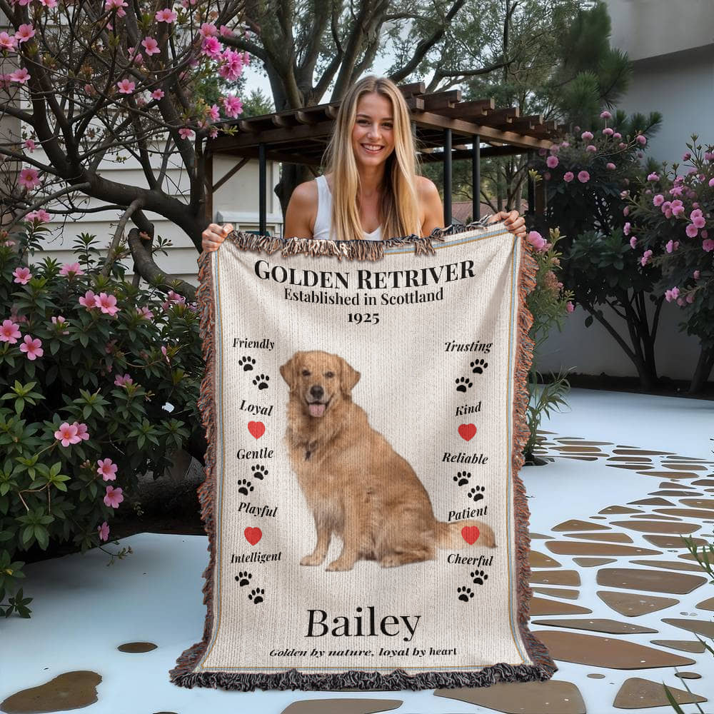 Woman holding a Golden Retriever-themed woven blanket with traits text and a personalized dog photo and name illustration.