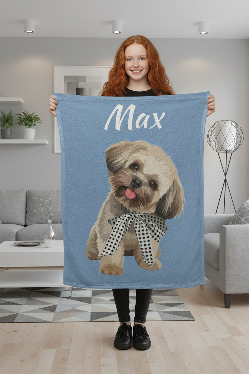Woman holding a blue blanket with a dog illustration and 'Max' text in a living room.