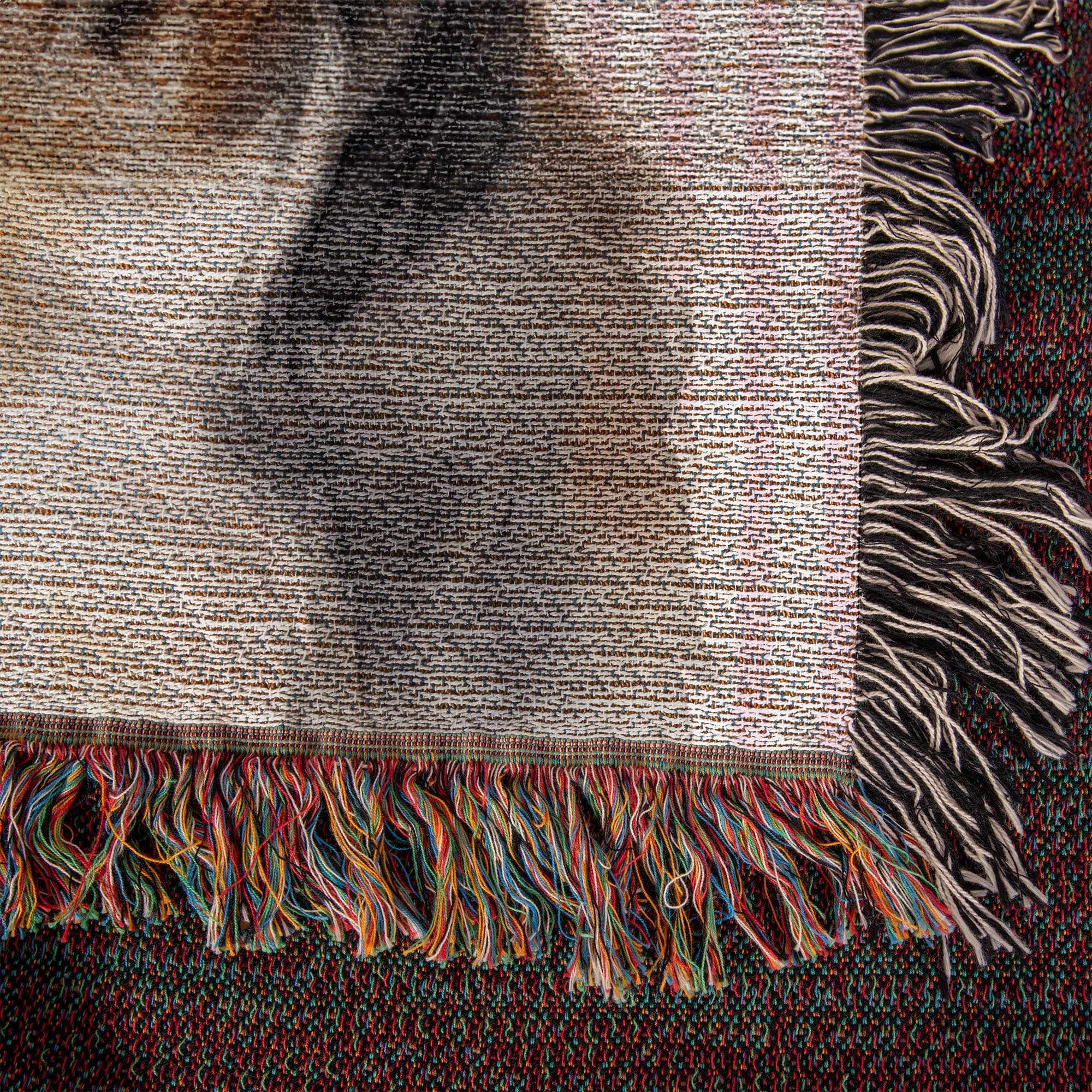 Textured fabric with colorful fringes on a dark background