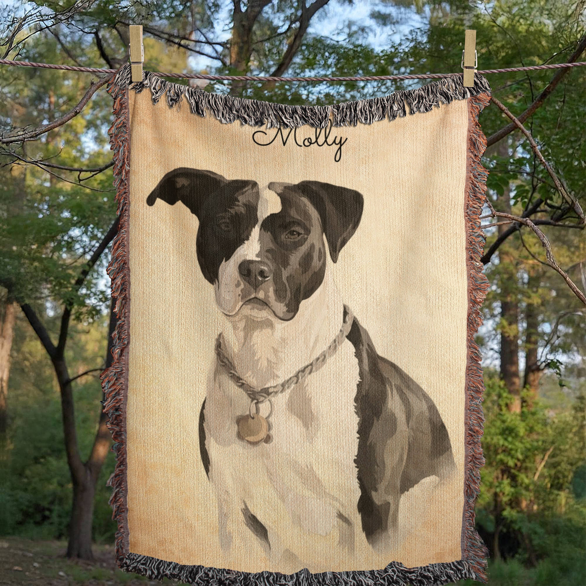 Blanket with a dog portrait and name 'Molly' hanging outdoors.