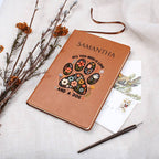 Brown notebook with floral paw design and text on a white fabric background