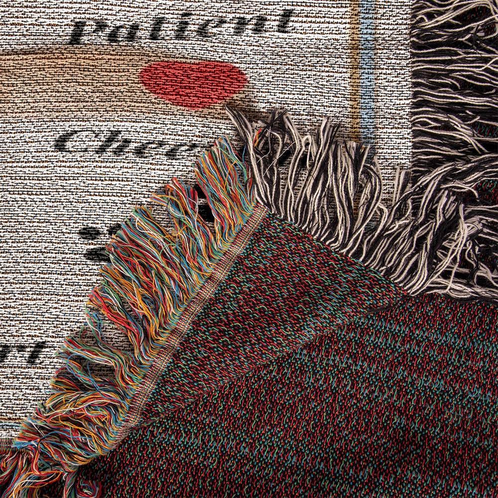 Textile with fringed edges on a textured background on the corner of a woven blanket