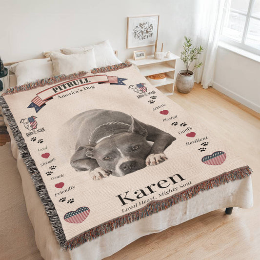 Pitbull-themed blanket with a dog's photo and text on a bed in a room.