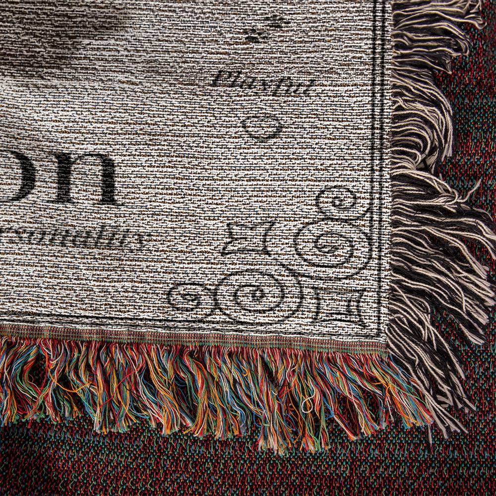Textile with classical design and fringes on a dark background