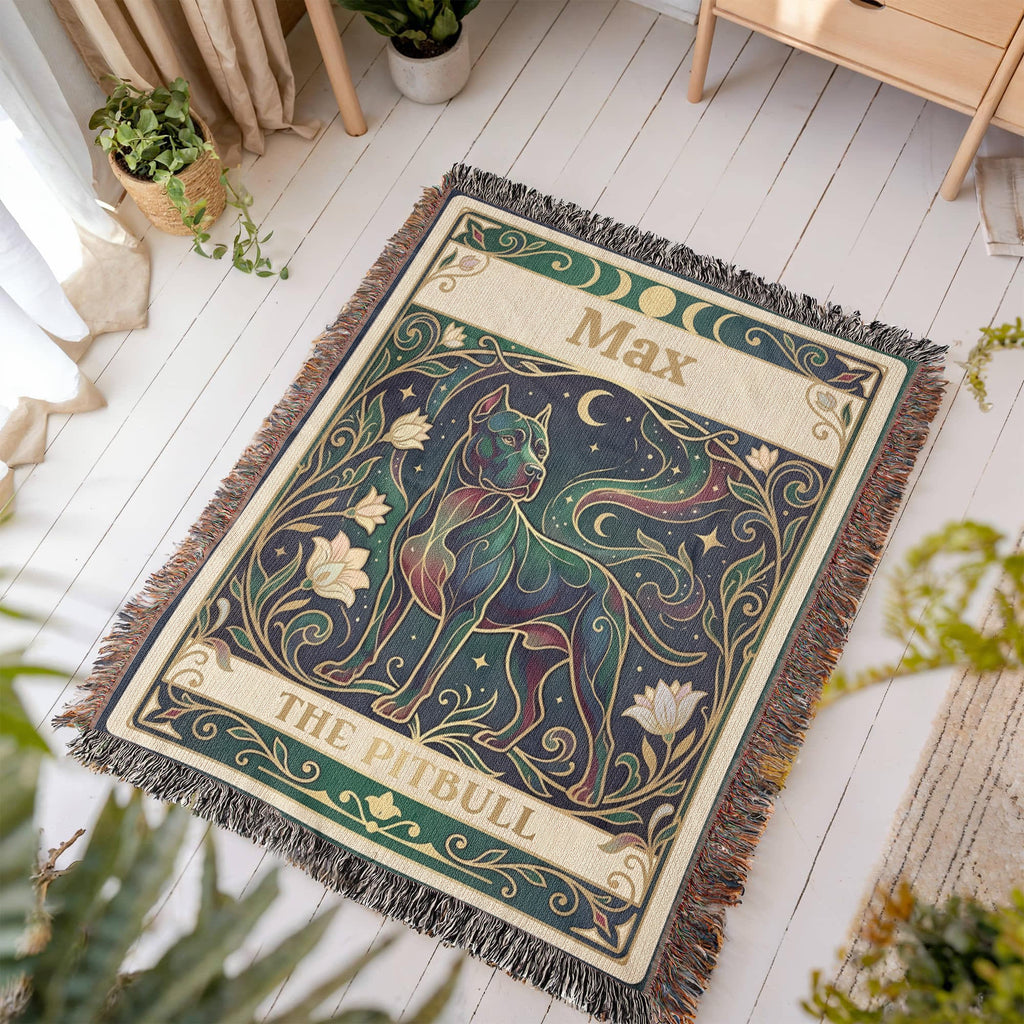 Decorative blanket with a pitbull tarot card design and personalized with the name 'Max' printed on it, placed on a wooden floor.