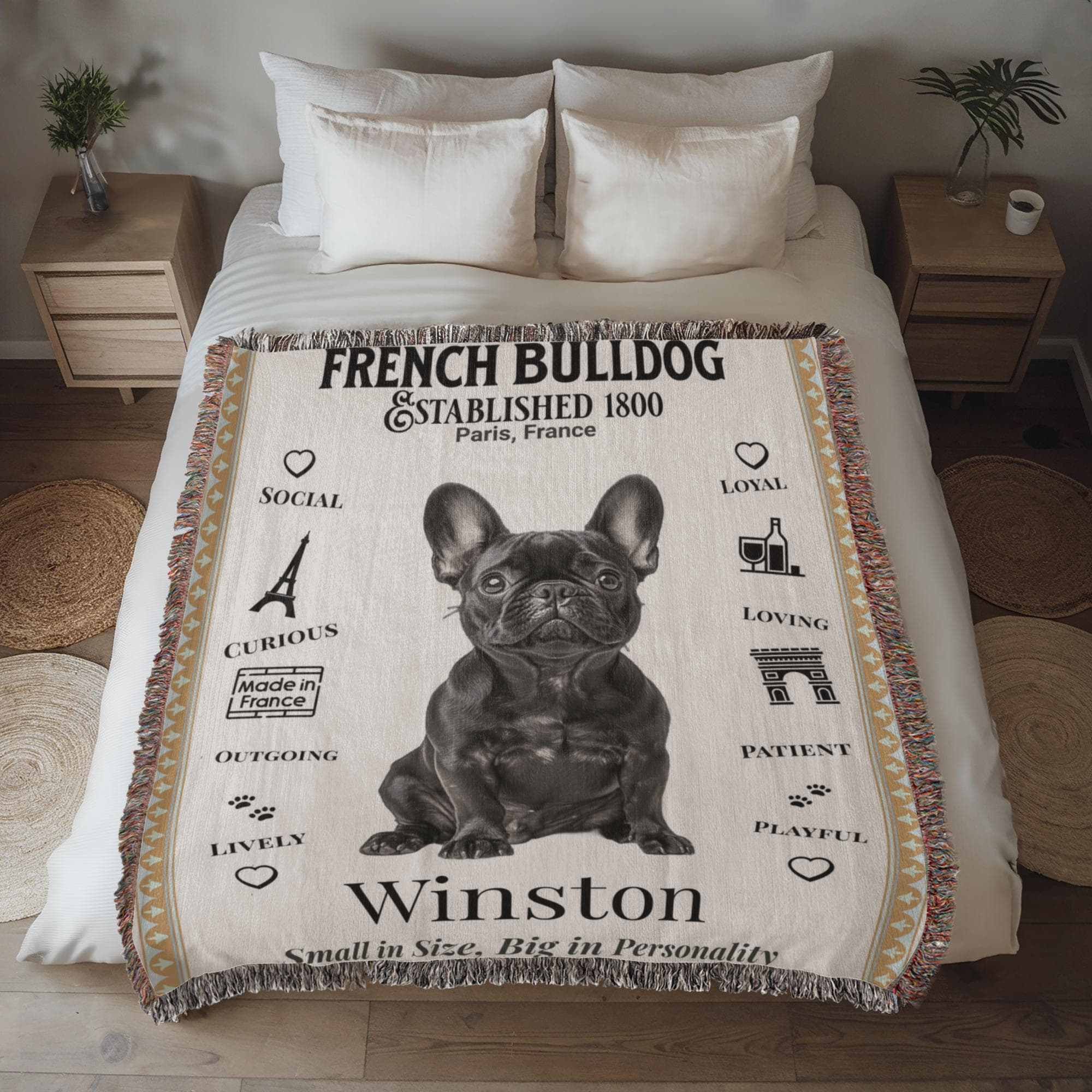 Blanket with a French Bulldog design and text on a bed in a bedroom setting.Personalized with your Frenchie's name and photo.