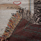 Close-up of a textured fabric with colorful fringes and a blurred background on a woven blanket.