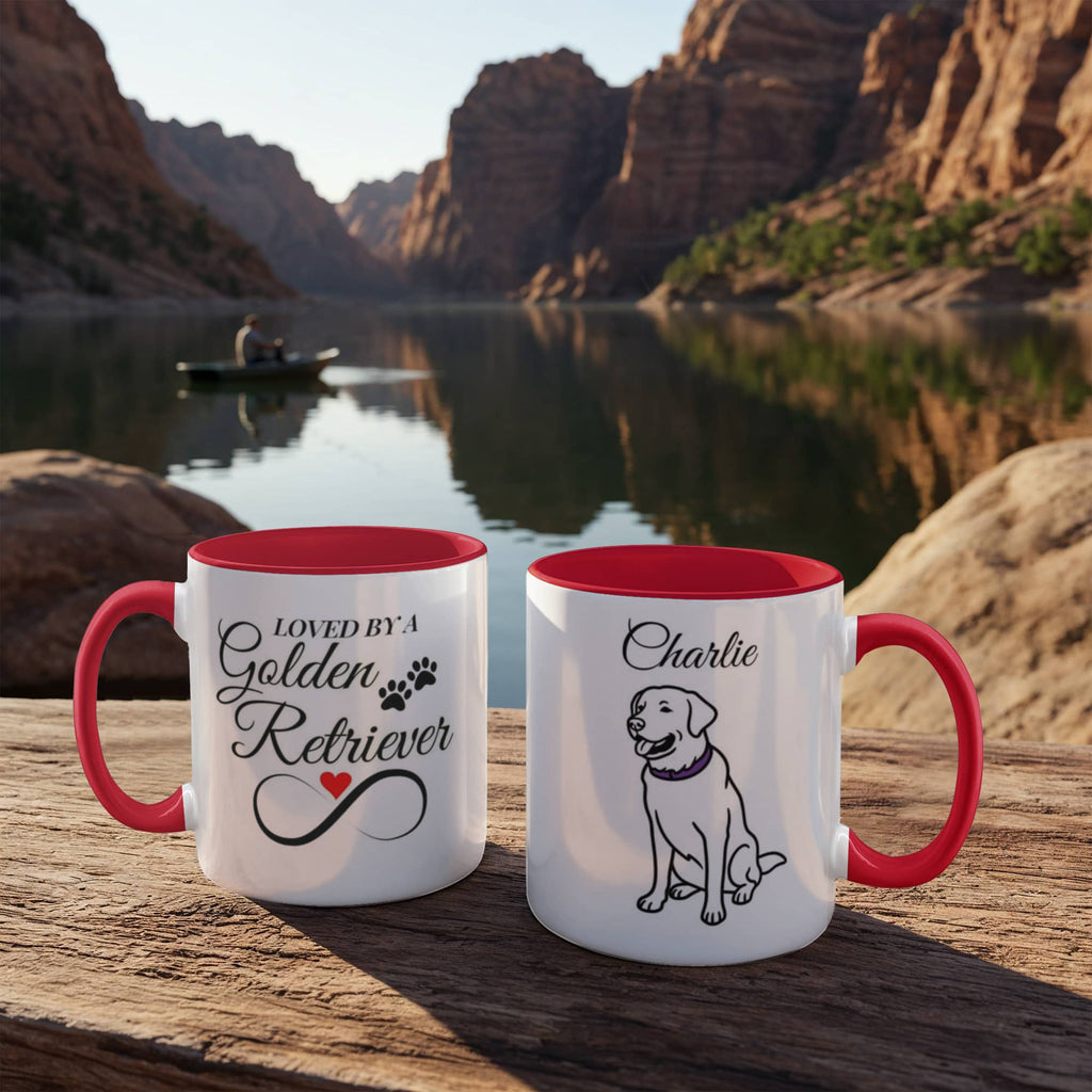 Two mugs with red interior and handles on a wooden surface with a scenic background of a lake and mountains.