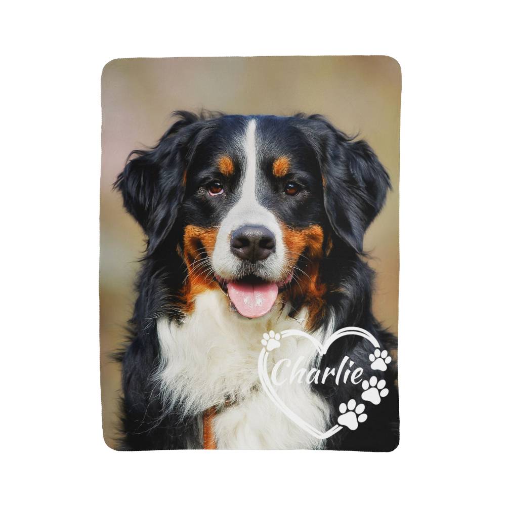 Dog with 'Charlie' and paw prints on a brown background